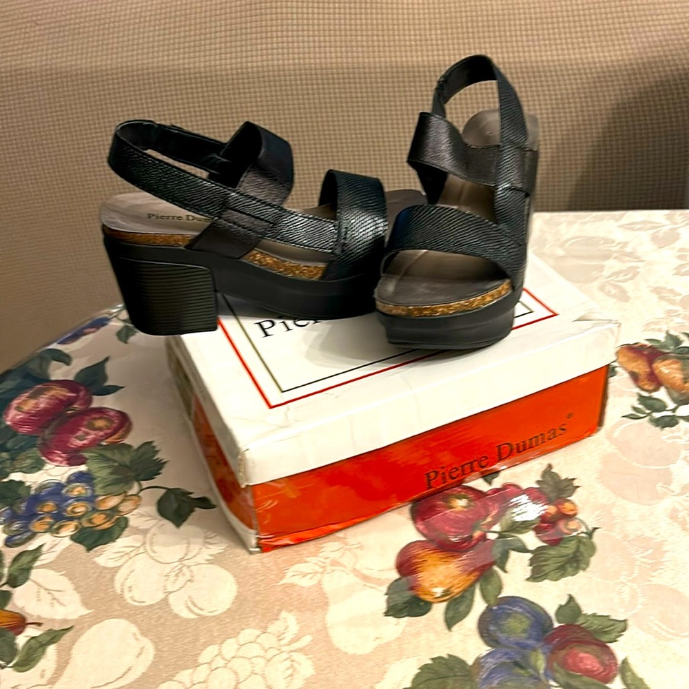Sling back platform like sandals. Super comfy. Only worn once.